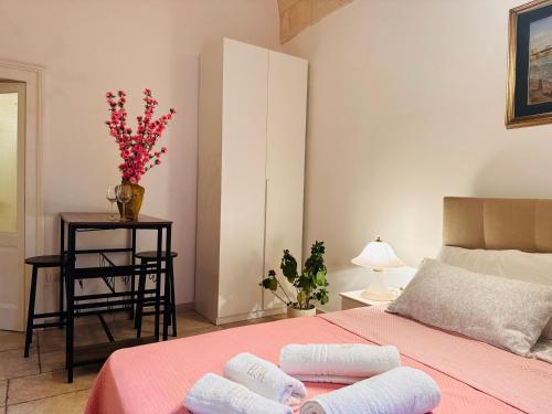 a bedroom with a bed with two towels on it at Dimora Iryna in Monopoli