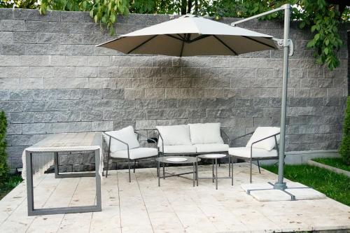 a table and chairs and an umbrella on a patio at Garden Hills in Garni