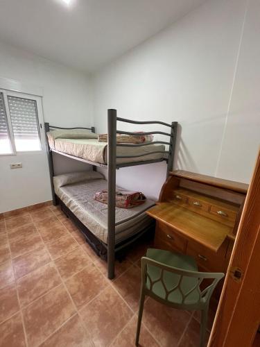 a room with two bunk beds and a desk at Casa Darío in Ceuta