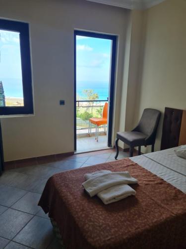 a bedroom with a bed with two towels on it at Sun Fire Beach Hotel - All Inclusive in Alanya