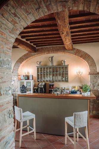 a kitchen with two chairs and a bar in a building at Tenuta Lupinari in Bucine