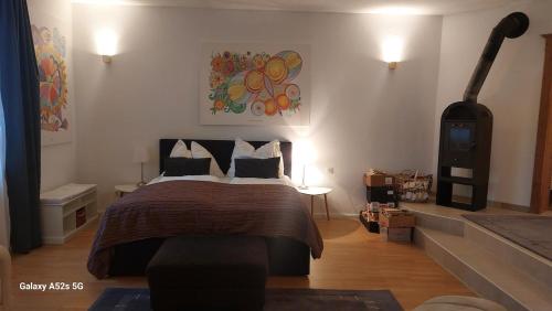 a bedroom with a large bed and a fireplace at Apartment FreiRaum in Innsbruck