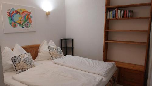 a bedroom with a bed with white sheets and pillows at Apartment FreiRaum in Innsbruck