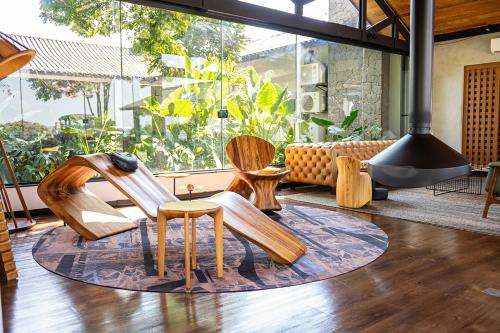 a group of wooden chairs sitting in a living room at NÖR Hotel & SPA in São Roque