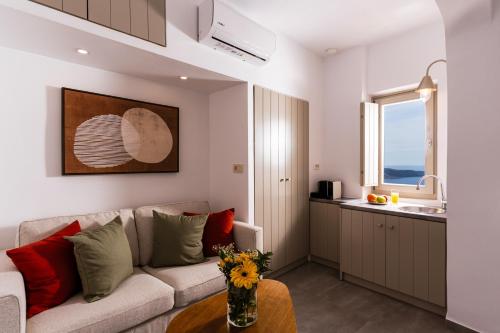a living room with a couch and a table at Mardanza Krokos Suites in Imerovigli