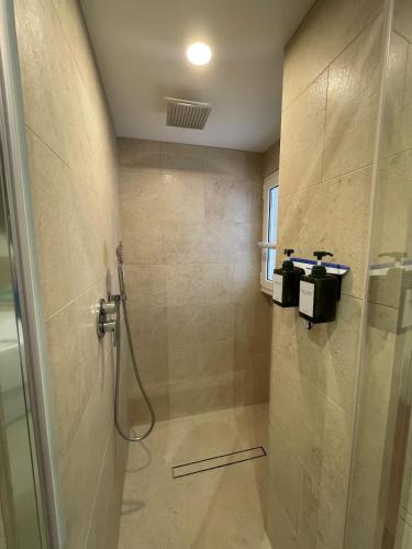 a bathroom with a shower with a glass door at carpe diem sistina in Rome