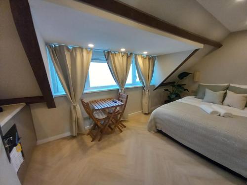 a bedroom with a large bed and a window at Family Double floor top view Art Apartment R3&5 in The Hague