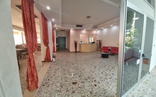 a hallway with a room with a table and chairs at Hotel Anny in Cervia