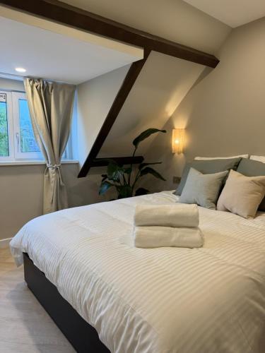 a bedroom with a large bed with white sheets at Family Double floor top view Art Apartment R3&5 in The Hague