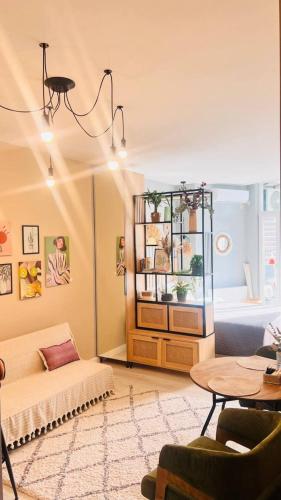 a living room with a couch and a table at Boho apartment studio in Batumi