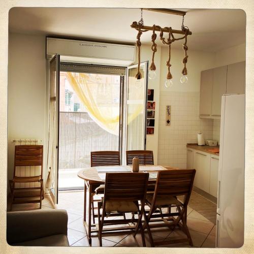 a kitchen and dining room with a table and chairs at Casa di Emma in Vado Ligure