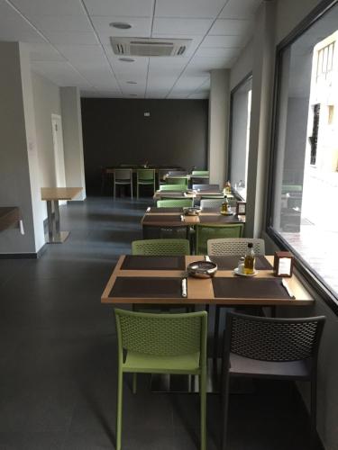 a dining room with tables and chairs and a blackboard at La Perla in Almería