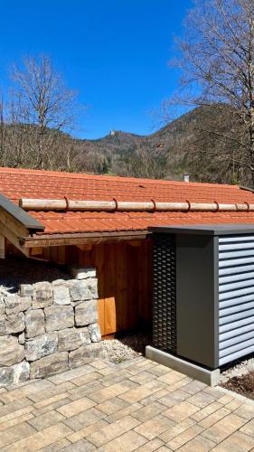 a building with a roof and a stone wall at Leos Wallbergblick in Rottach-Egern