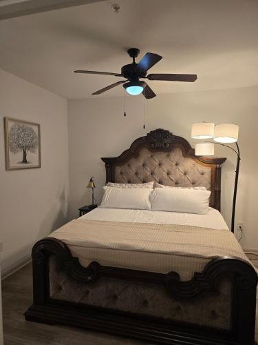 a bedroom with a large bed with a ceiling fan at Comfy Apartment in Frisco in Frisco