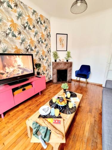 un salon avec une télévision et une table dans l'établissement Appartement 42m2 - Calme & confort - Paris & aéroport d'Orly à 15 min, à Antony