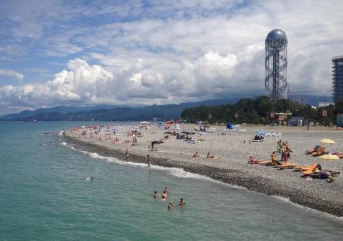 a beach with a bunch of people in the water at Hotel Intourist Palace Batumi in Batumi