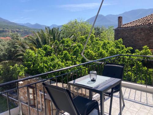 a table and chairs on a balcony with a view at Selini Apartments Mani in Agios Nikolaos