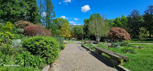 a park with a bench and a walkway at Dorolea Rooms Torino Centro in Turin