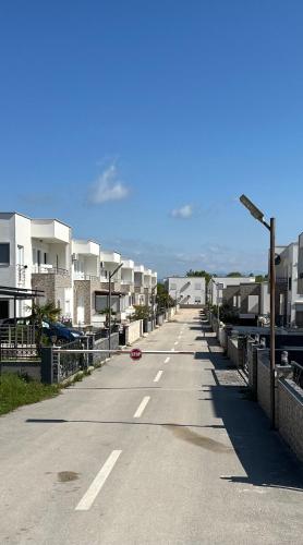 an empty street with a row of apartment buildings at Vila Dior Donji Stoj in Donji Štoj