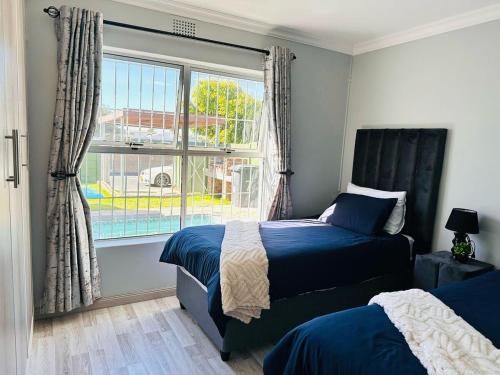 a bedroom with a bed and a window at Casa Da Gama Luxe in Marina Da Gama