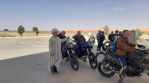 a group of men standing next to their motorcycles at Trek desert Morocco Sarl in Taouz
