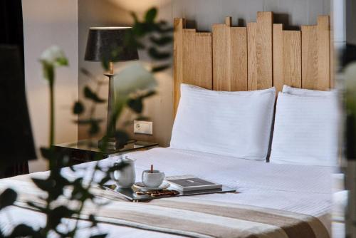 a bed with a table with a laptop on it at Despotiko in Portariá