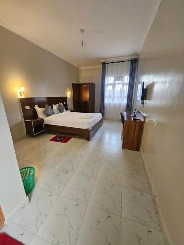 a large bedroom with a large bed and a room with at Grand Amoena Guest house in Naivasha