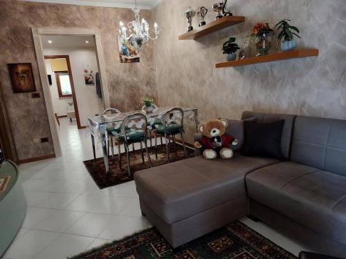 a teddy bear sitting on a couch in a living room at CasaF - Appartamento con parcheggio privato in Velletri