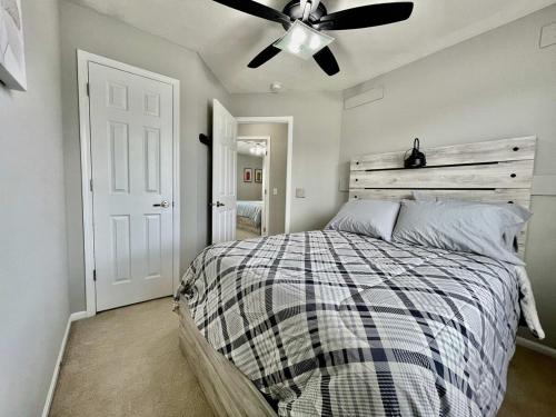 a bedroom with a bed and a ceiling fan at Fresh West Omaha Home For Your Entire Group in Omaha