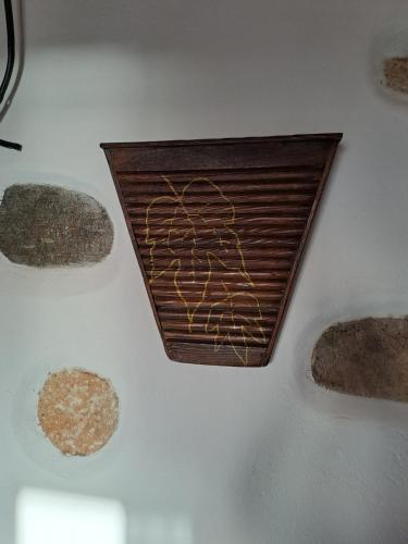 a wooden plate with some rocks on a wall at Traditional house paros in Sarakíniko
