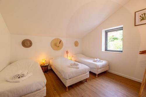 a room with two beds and a window at La Ressource Malix, spa, panoramic view, spacious in Tenay