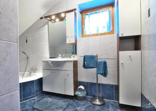 a bathroom with a sink and a mirror at Familienappartement Seppenbauer in Bad Ischl