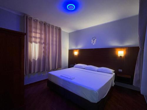a bedroom with a large white bed in a room at Amasisa Casa Vacacional Sauce, Laguna Azul in Sauce