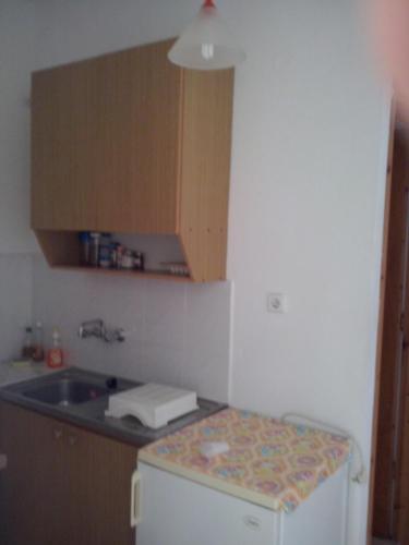 a small kitchen with a sink and a refrigerator at Diamont Studios in Agia Galini