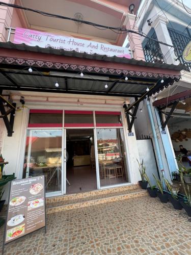 a store front with a sign in front of it at Catty tourist house in Thakhek