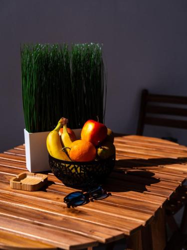 a bowl of fruit on a wooden table at Pellarhome Quality Guest House in Pellaro