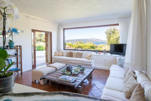 a living room with a couch and a table at Exclusive Villa in Porto Rotondo with jacuzzipool in Porto Rotondo