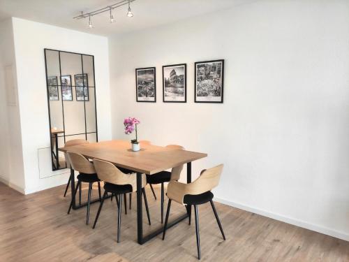 a dining room with a wooden table and chairs at Top duplex Apartment Zurich-Limmattal in Killwangen