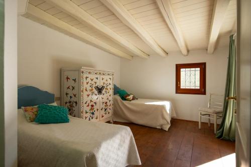 a bedroom with two beds and a window and a table at Exclusive Villa in Porto Rotondo with jacuzzipool in Porto Rotondo
