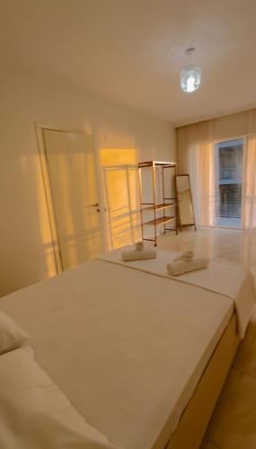 a large white bed in a room with two mirrors at WoodSea in Batumi