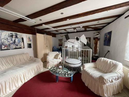 a living room with two white couches and a table at Atelier Suite in Reutlingen