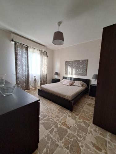 a bedroom with a bed in a room with a stone floor at Vistamare in Marina di Cecina