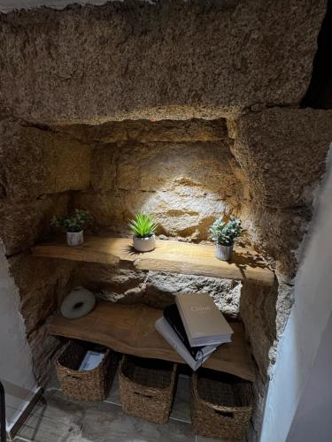 a stone wall with a table with a book on it at appartement de standing avec jacuzzi exterieur in Zonza