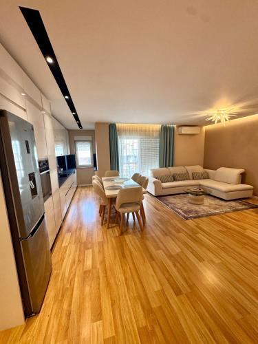 a living room with a couch and a table at Tirana Lake Spacious Apartment in Sauk
