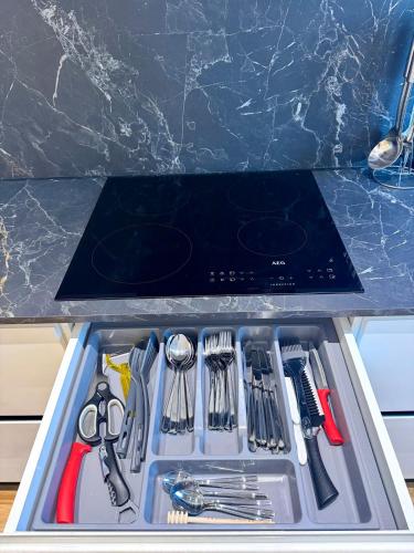 a drawer filled with utensils in a kitchen at Tirana Lake Spacious Apartment in Sauk