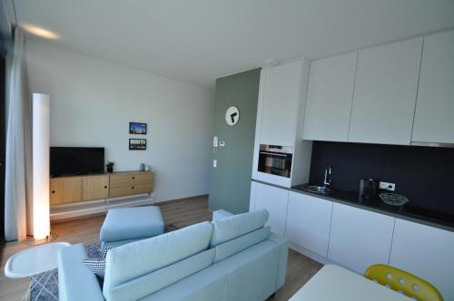 a living room with a couch and a table at Cadix 35 in Antwerp