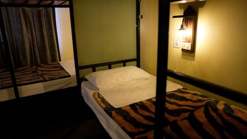 Ένα ή περισσότερα κρεβάτια σε δωμάτιο στο Rafiki Hostel