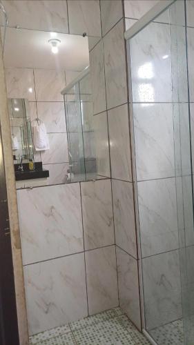 a bathroom with a large shower with a mirror at Harmonia em sintonia in Alto Paraíso de Goiás