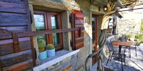 a porch of a house with a bench and windows at Studio Apartment Belvedere in Grožnjan