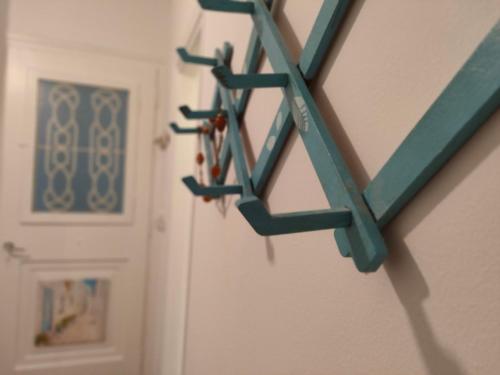 a group of hooks on a wall next to a door at Naxos Crafts' House in Naxos Chora